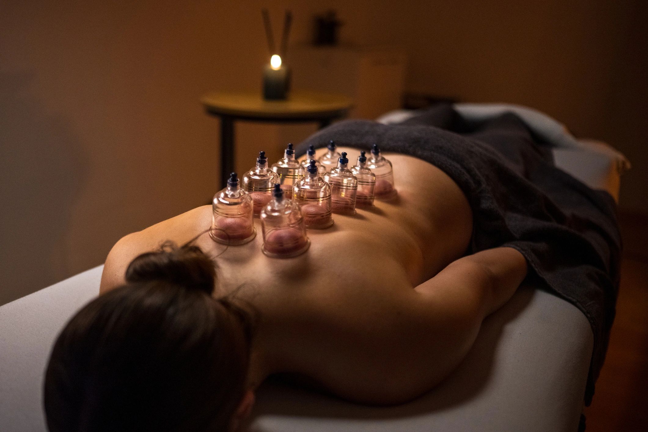 Woman receiving a relaxing wellness treatment in a spa room
